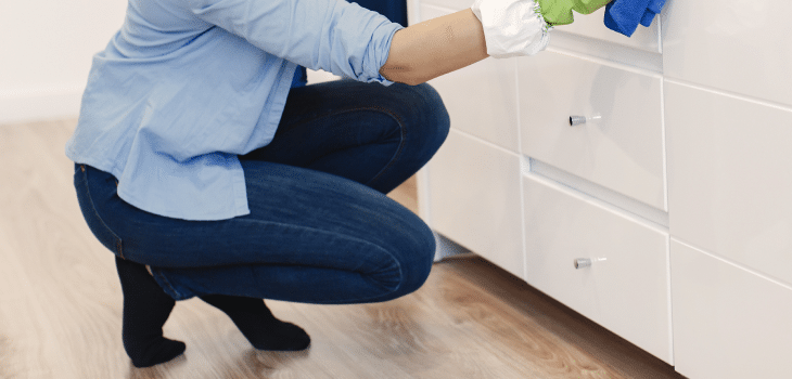 woman with sponge rubber gloves cleaning house