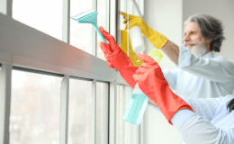 Mature Couple Cleaning Window