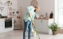 Young Man Hoovering Carpet Home